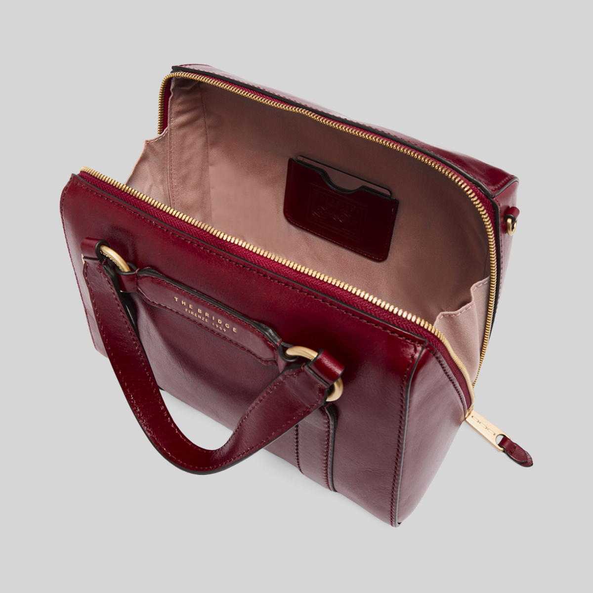 Borsa a mano LIBUTTI in pelle bordeaux con cerniera dorata e interno foderato, vista dall'alto