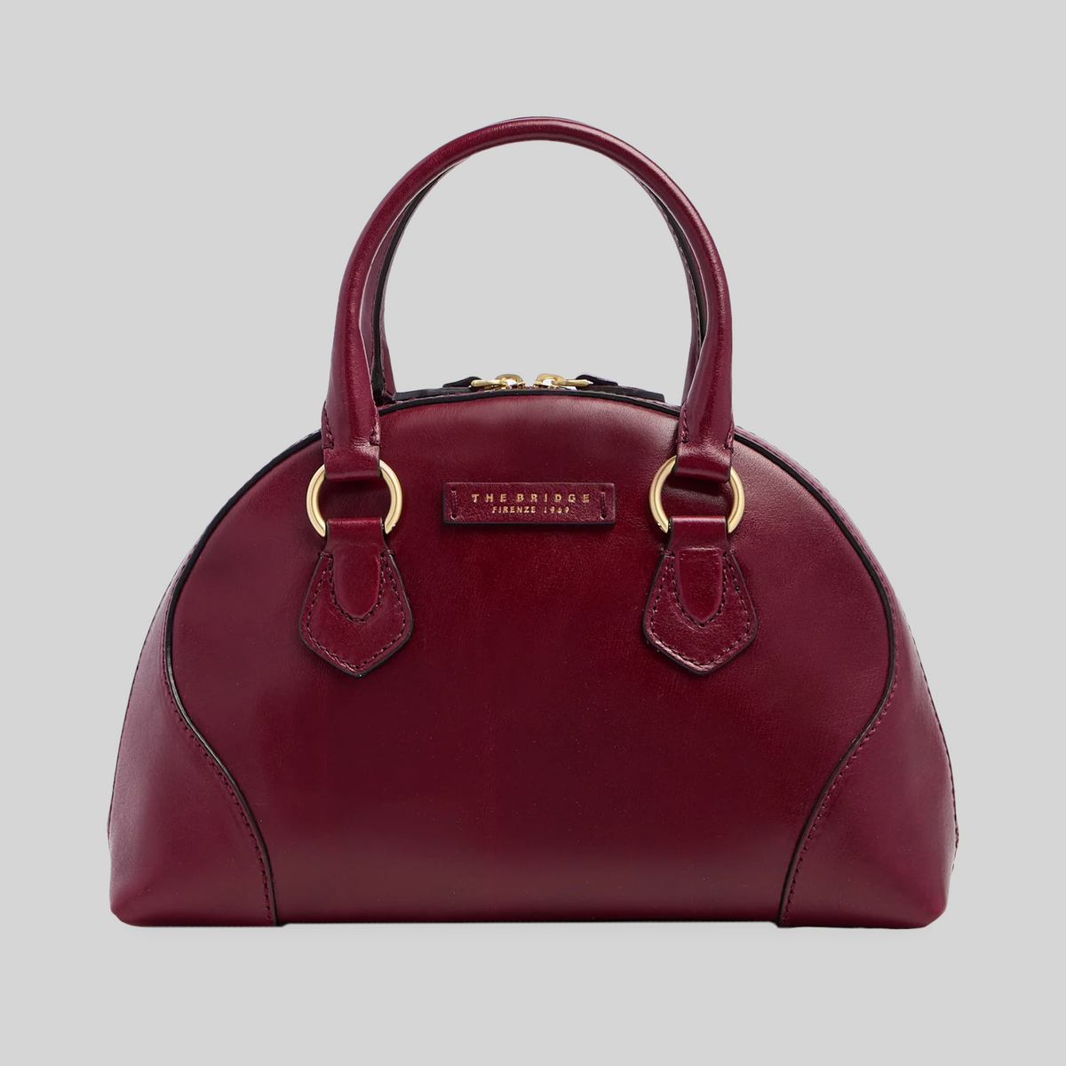 Borsa LIBUTTI in pelle bordeaux dal design arrotondato con manici e dettagli in metallo dorato