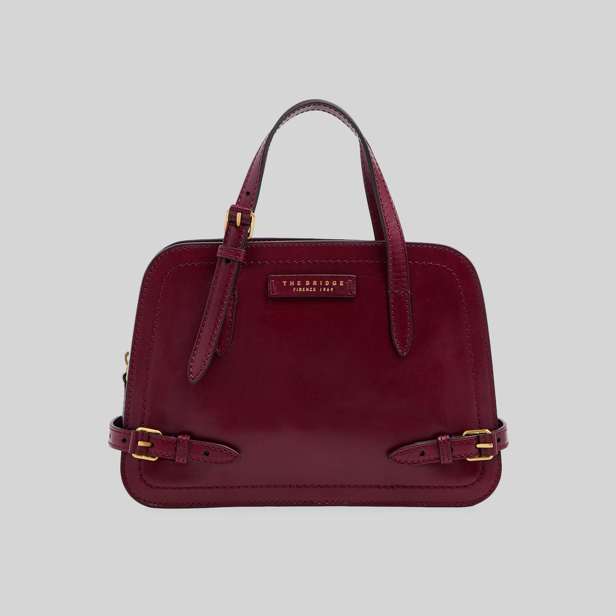 Borsa LIBUTTI The Bridge linea Monica in cuoio bordeaux con dettagli in metallo dorato e fibbie laterali