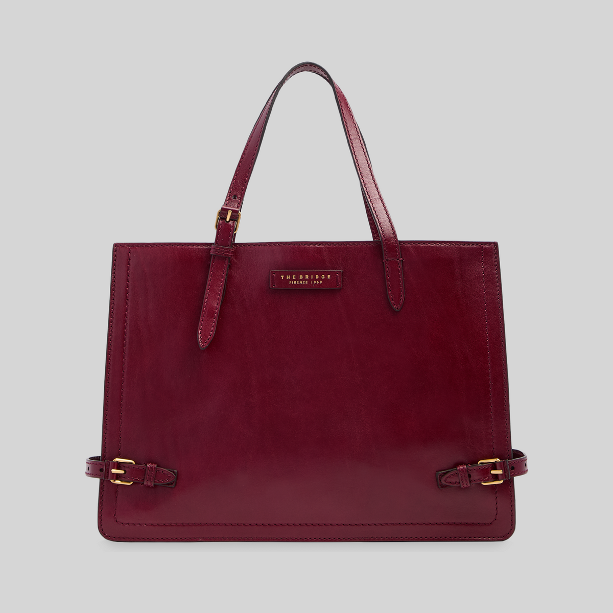 Borsa shopping LIBUTTI in pelle bordeaux con manici regolabili e dettagli in metallo dorato, design italiano elegante.