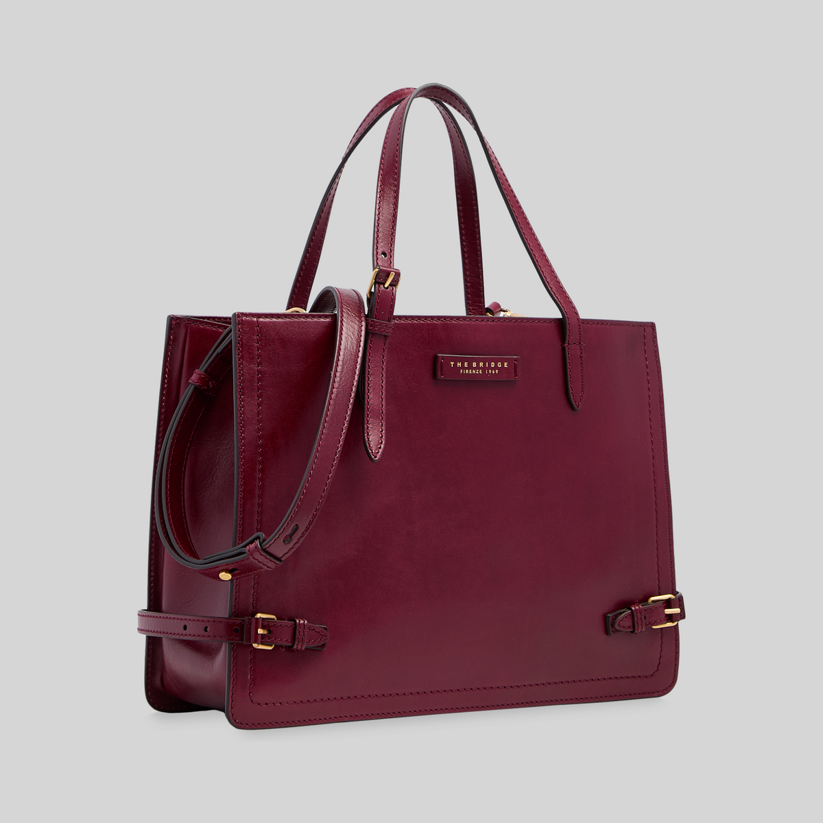 Borsa shopping LIBUTTI in pelle bordeaux con tracolla regolabile, manici lunghi e dettagli in metallo dorato.