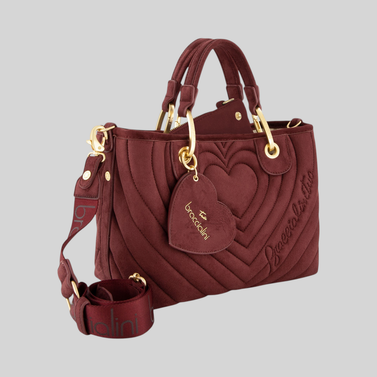 Borsa a mano LIBUTTI in suede bordeaux con trapuntatura a cuori, doppi manici, tracolla logata e pochette interna.