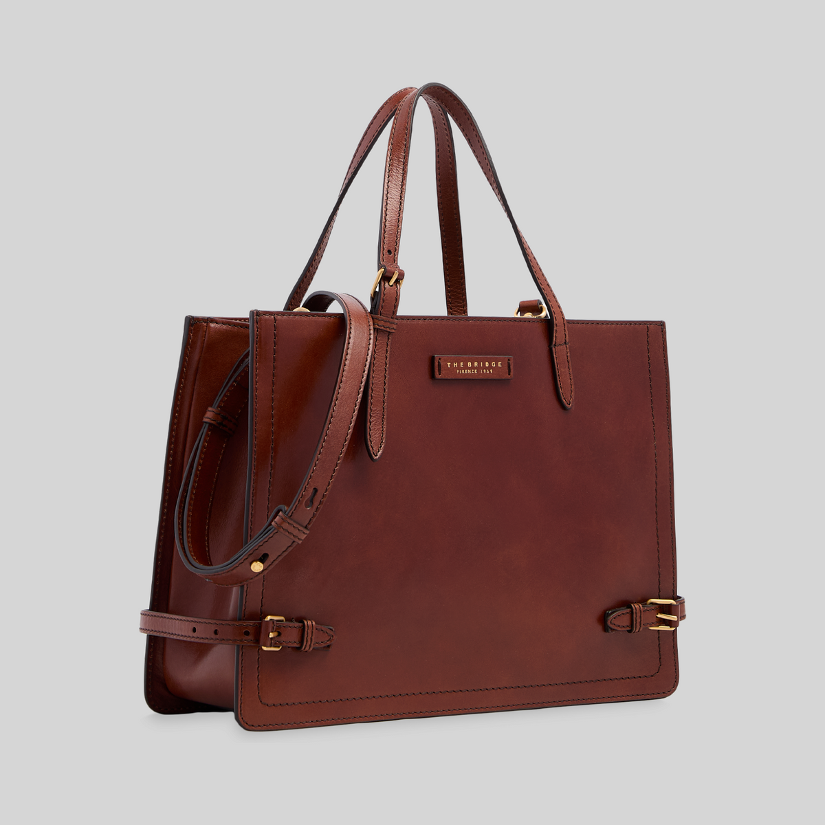Borsa shopping LIBUTTI in pelle marrone pieno fiore con tracolla regolabile, manici lunghi e dettagli in oro.