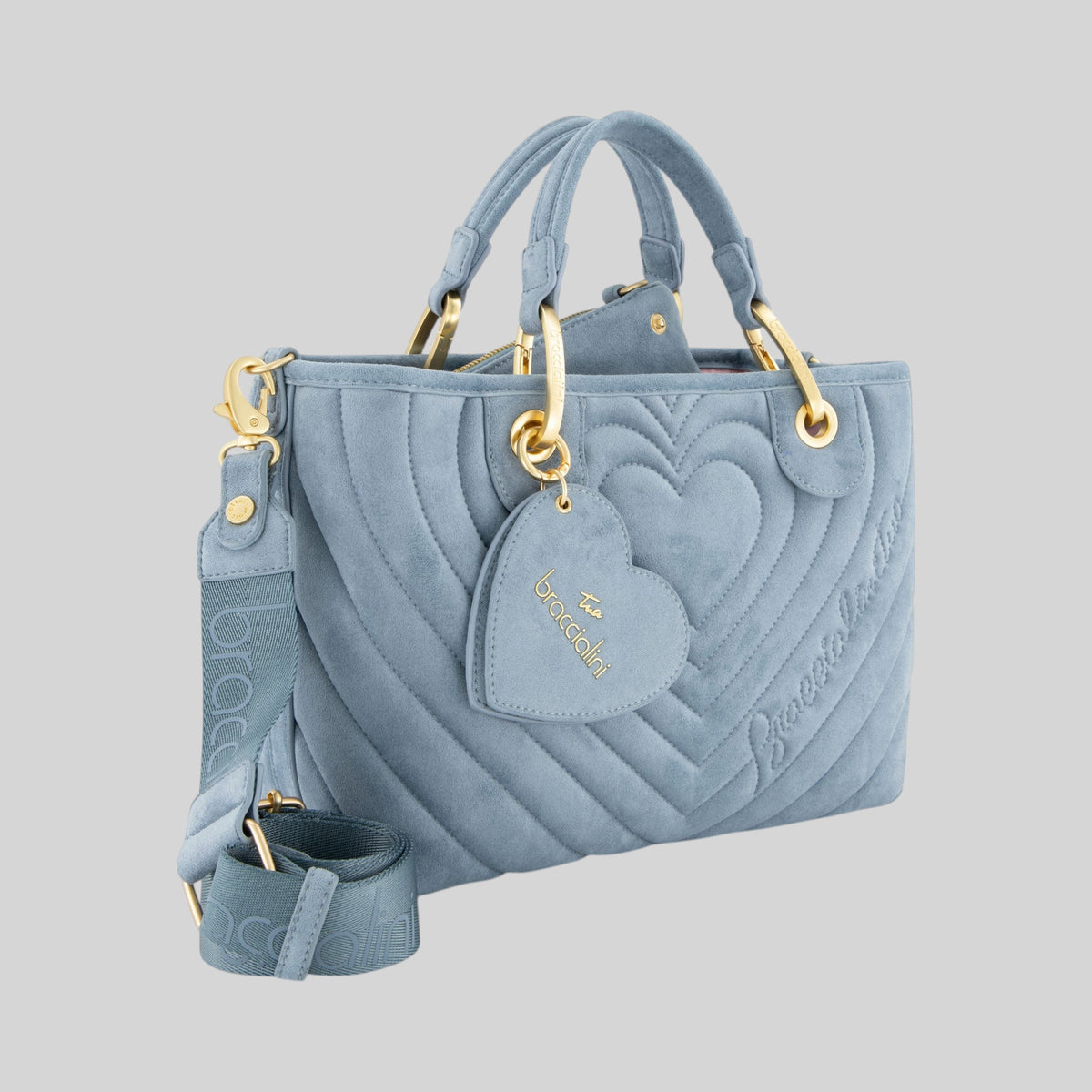Borsa a mano LIBUTTI in suede azzurro con trapuntatura a cuori, doppi manici, tracolla logata e ciondolo a cuore.