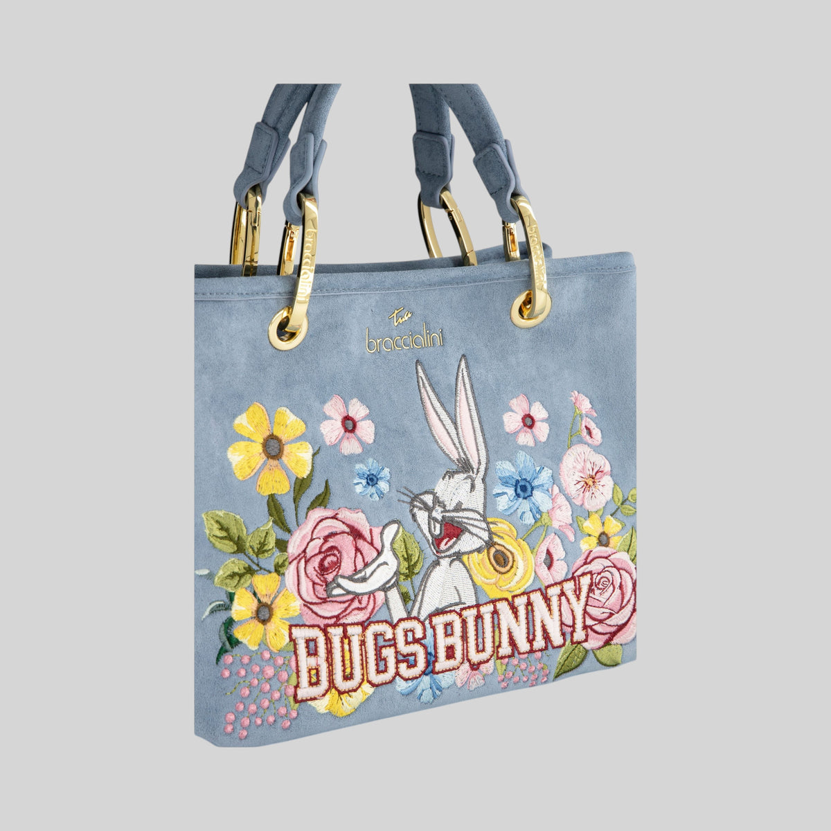 Borsa LIBUTTI in suede color polvere con ricamo di Bugs Bunny e fiori, dettagli dorati e manici eleganti