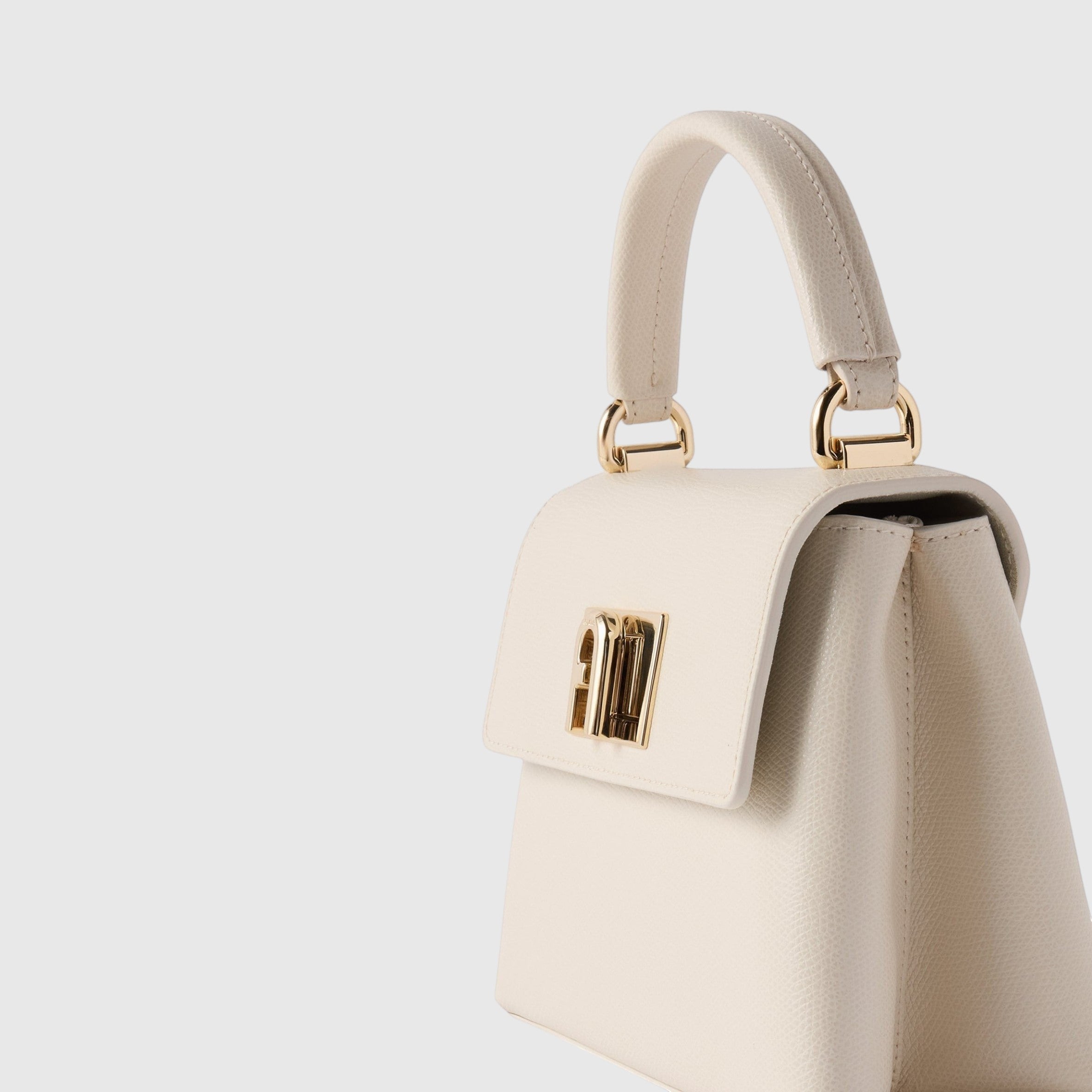 Mini borsa a mano LIBUTTI Furla 1927 in pelle color crema con chiusura a girello dorata e logo Arco